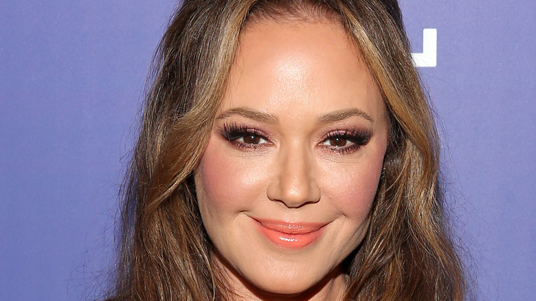 Leah Remini smiles at an event