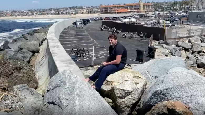 Brogan Kurth sitting by the beach