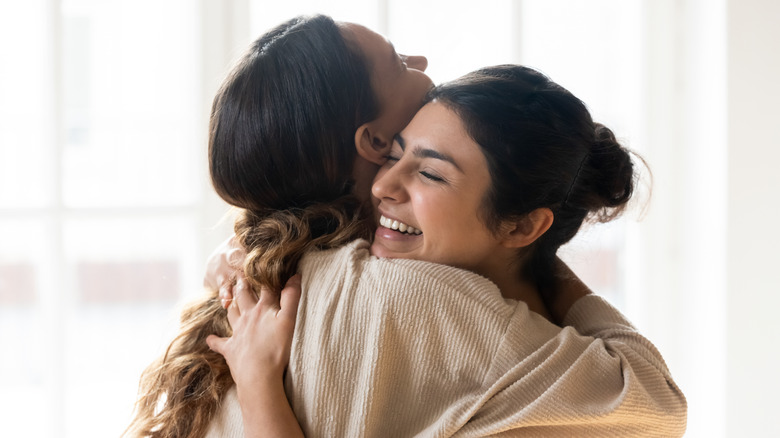 two female friends hugging