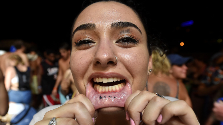 girl with inner lip tattoo