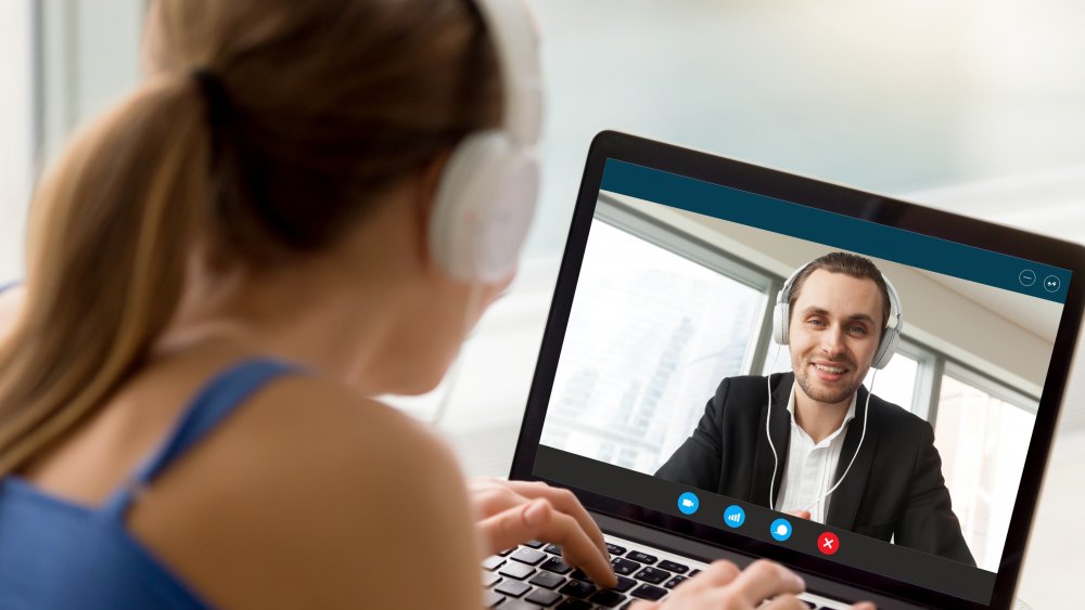 Woman in a long-distance relationship talking to her boyfriend on a computer