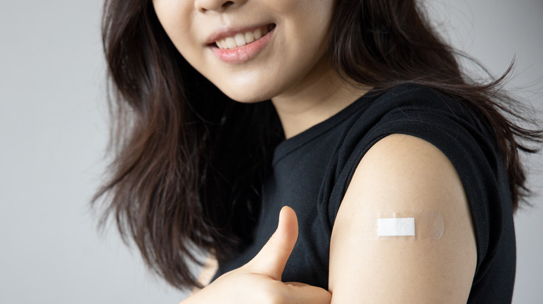 Woman with bandaid on her arm
