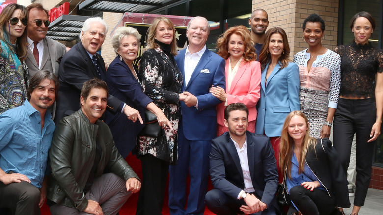 Days of Our Lives cast members pose for a photo. 