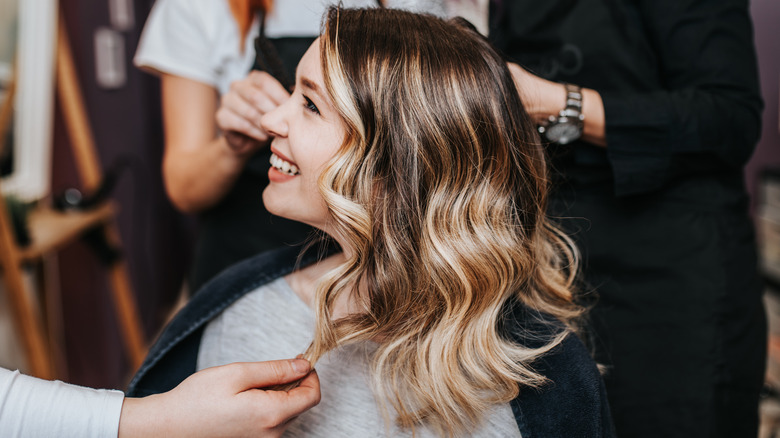 Woman gets a balayage hair color treatment at the salon