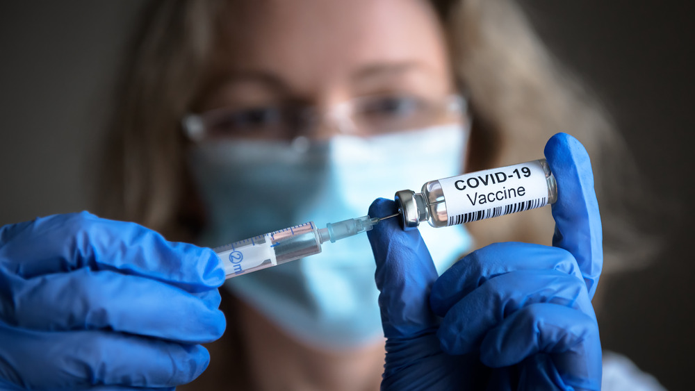 Woman holding COVID vaccine