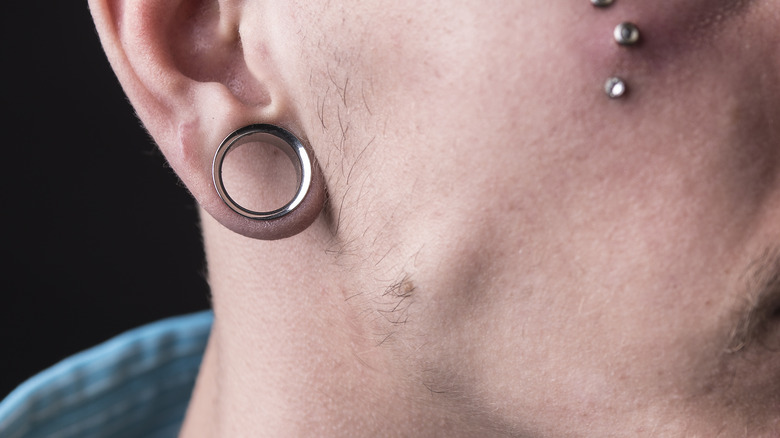 man with gauged ear