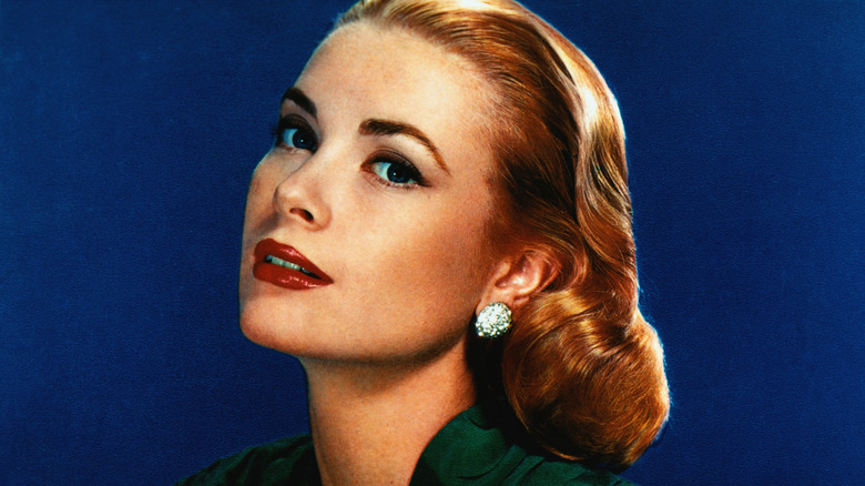 Portrait of Grace Kelly wearing diamond earrings and green top