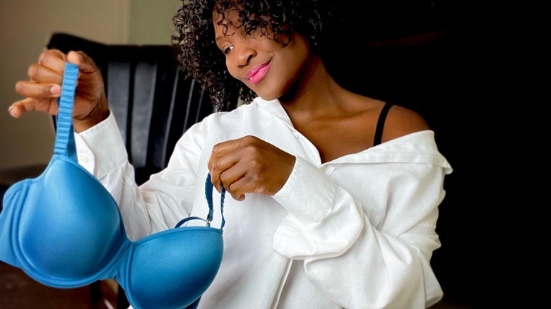 woman holding blue bra