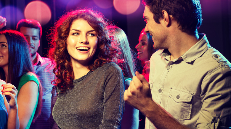 woman smiling at man at party