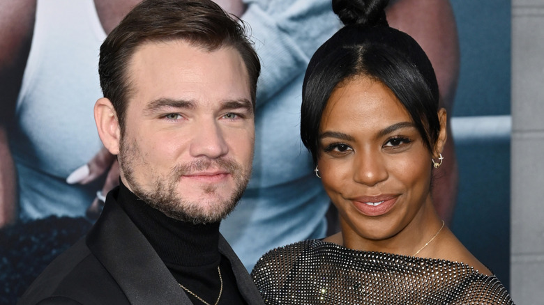 The couple smiling at the camera