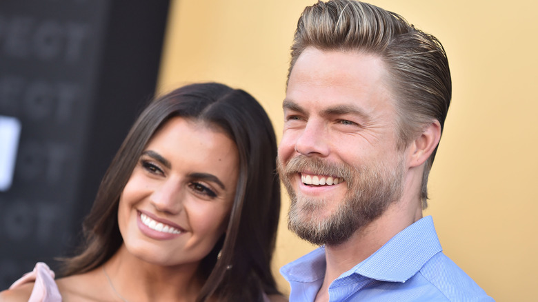 The couple smiling looking away from the camera