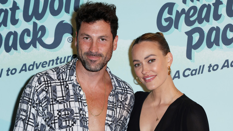 The couple smiling at the camera