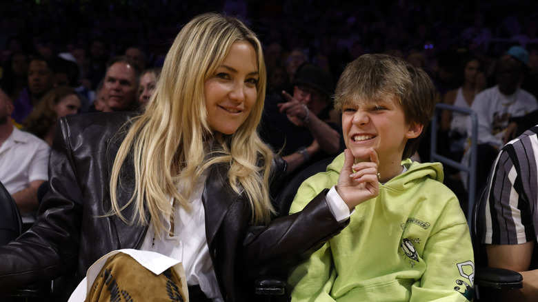 Kate Hudson holding Bingham Bellamy's chin at a basketball game in 2024