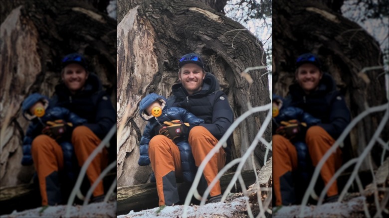Wyatt Russell posing with his son in front of a tree in 2025