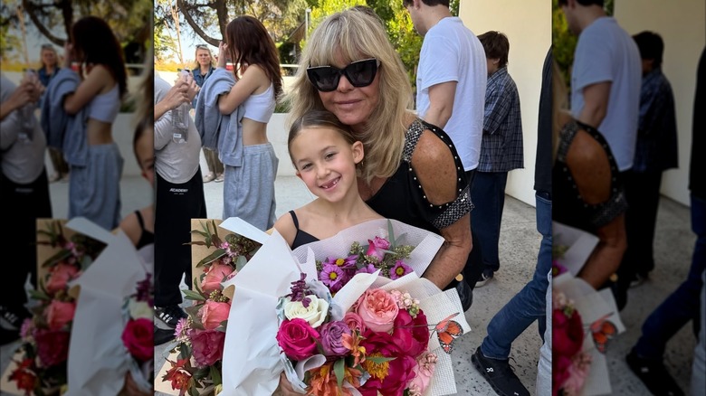 Rani Hudson Fujikawa holding flowers and posing with Goldie Hawn