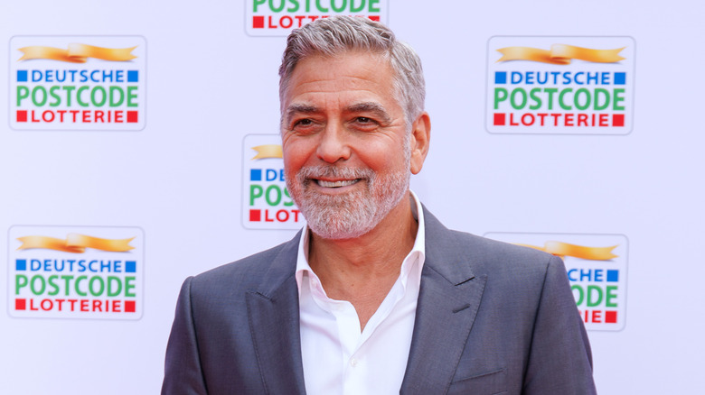 George Clooney smiling on the red carpet 