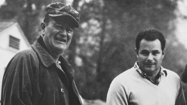 John Wayne and Michael Wayne in black-and-white