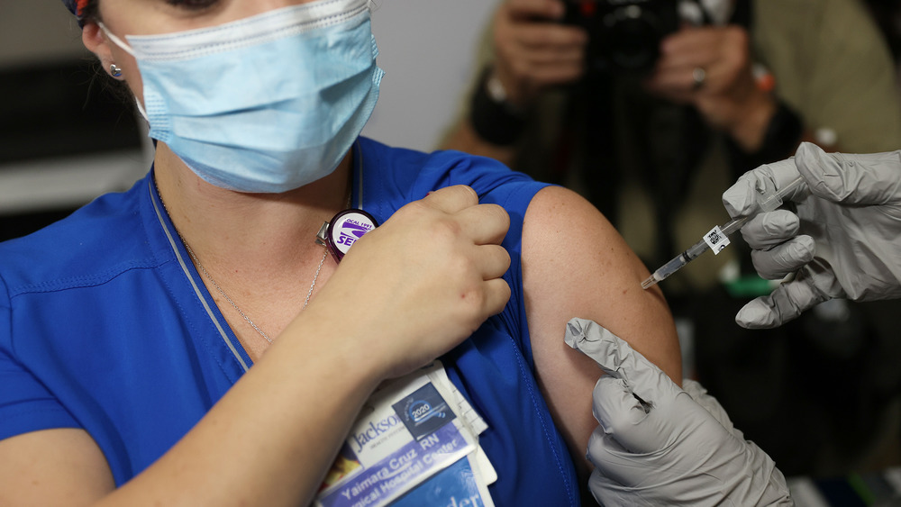 Woman receiving COVID-19 vaccination