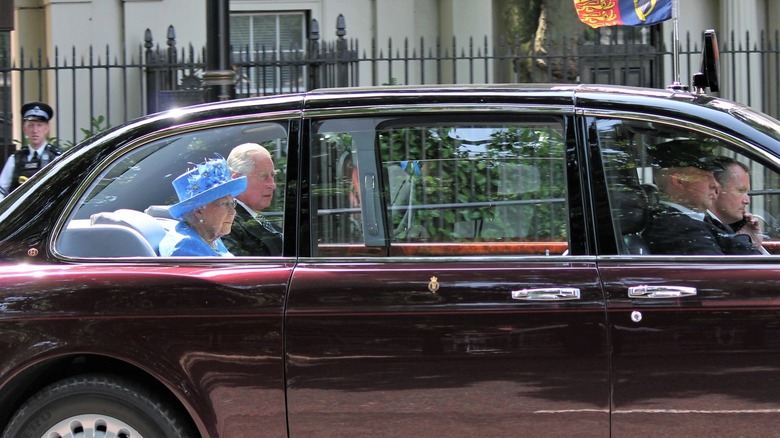 Prince Charles and the Queen being driven