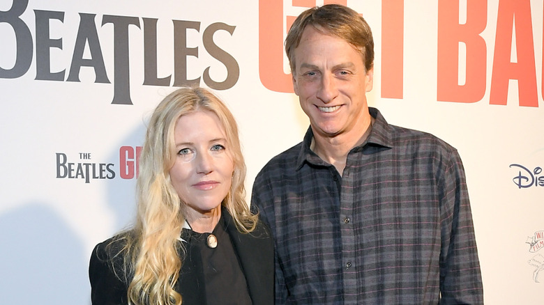 Cathy Goodman wearing black and Tony Hawk in a plaid shirt