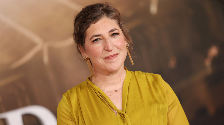 Mayim Bialik in a yellow dress and earrings