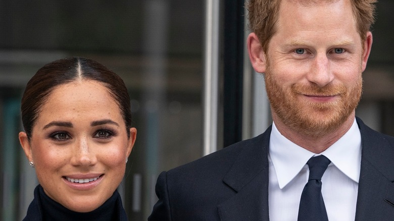 Meghan and Harry smiling at an appearance