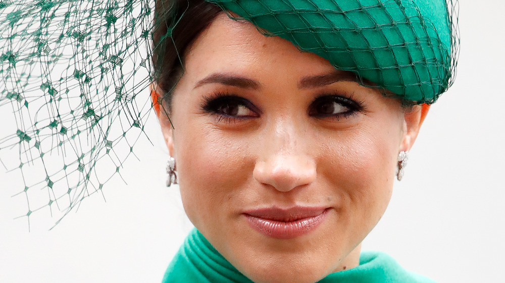 Meghan Markle wears a green hat with mesh