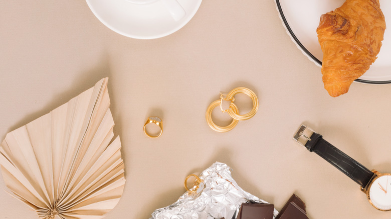 Earrings and rings in croissant flatlay