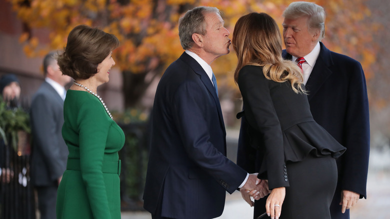 Former first lady Laura Bush and former President George W. Bush greet first lady Melania Trump and President Donald Trump outside of Blair House December 04, 2018.