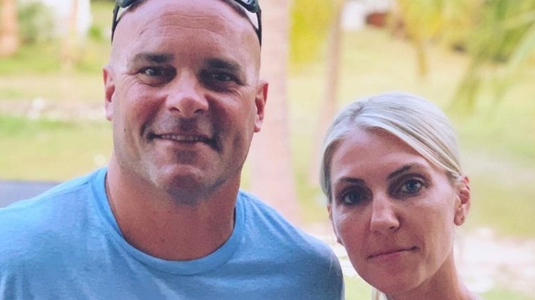 Bryan and Sarah Baeumler hold up a Canadian flag