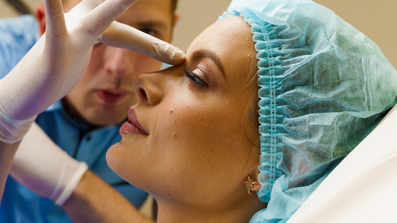 Woman consulting with plastic surgeon