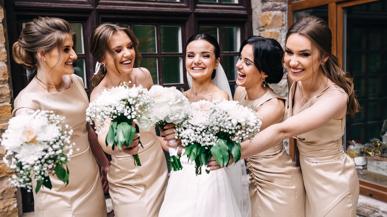 Smiling bride with her bridesmaids