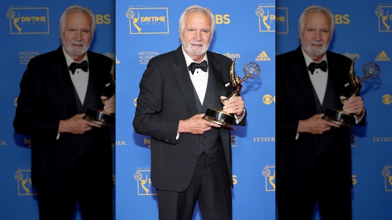 John McCook holding a Daytime Emmy