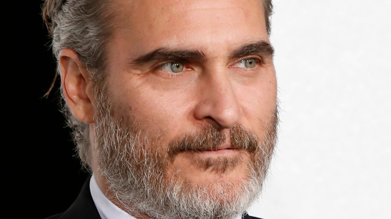 Joaquin Phoenix looking serious with facial hair