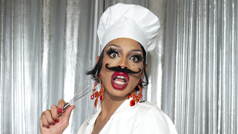Yvie Oddly poses as a chef
