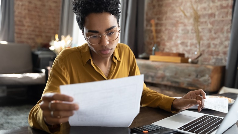 Black business woman concentrating on piece of paper