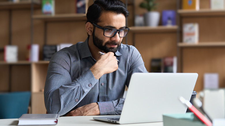 Focused Indian man working at desk