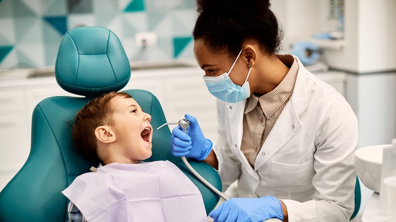 little boy with a dental hygienist