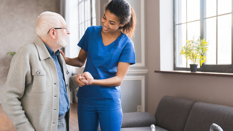 nurse helping an elderly woman