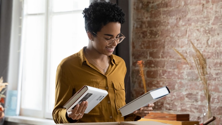 Librarian looking at books