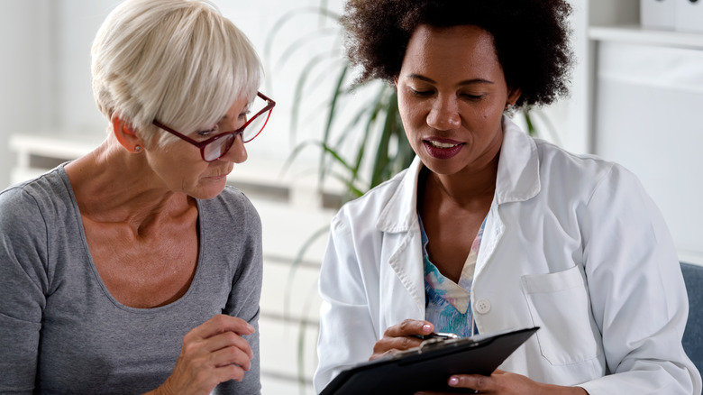 a doctor helping an older patient