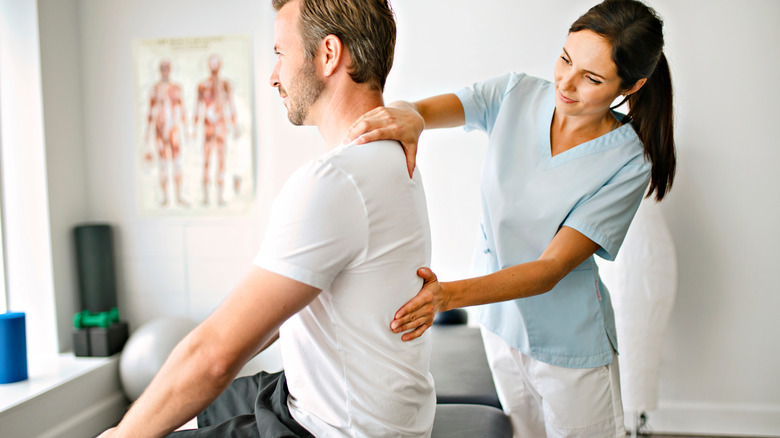 physical therapist with patient