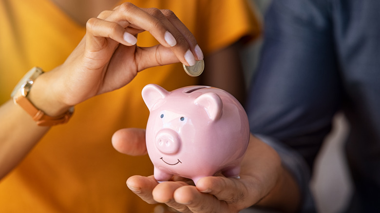 Couple holding a piggybank