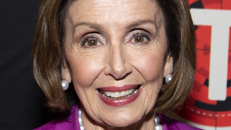 Nancy Pelosi smiling at theatre premiere 