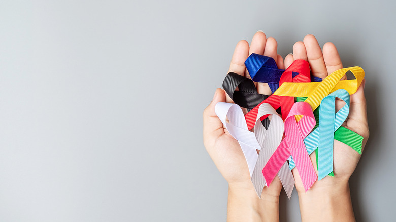hands holding different colored ribbons