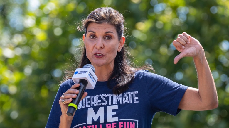 nikki haley points thumb down at rally