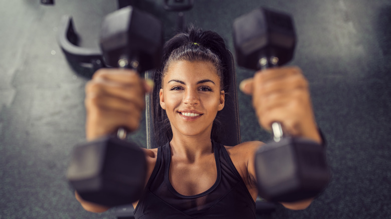 Woman using dumbells