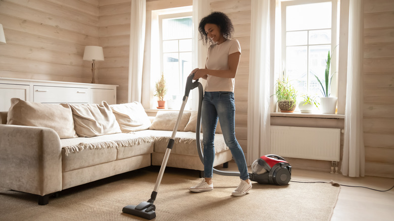 Woman vacuuming living room