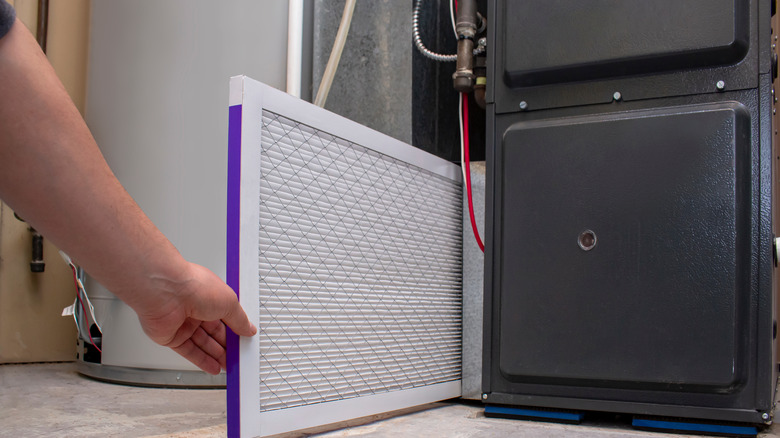 person changing air filter 