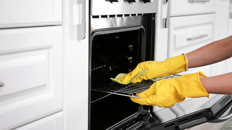 Person cleaning oven
